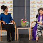 Teresa Kay-Aba Kennedy moderating an event with 96-year-old Yoga Master Tao Porchon-Lynch at the JCC Mid-Westchester on April 27, 2015